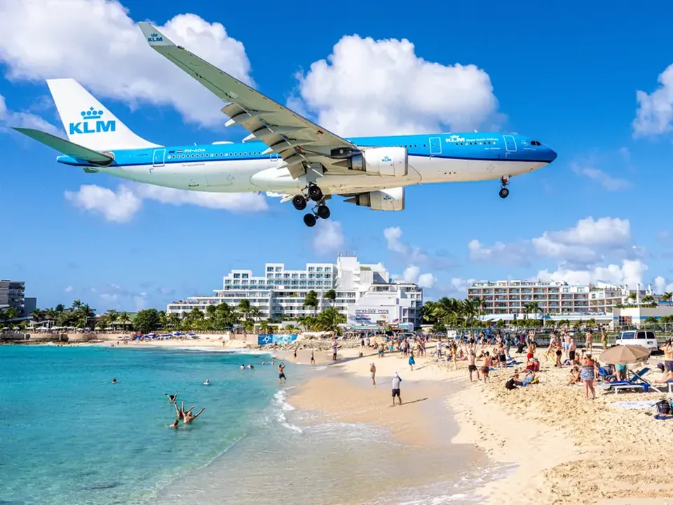 A passenger jet on final approach low over the beach in Sint Maarten